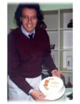 1986: Howard Skolnik holds a cake celebrating the first $500,000 month of sales!